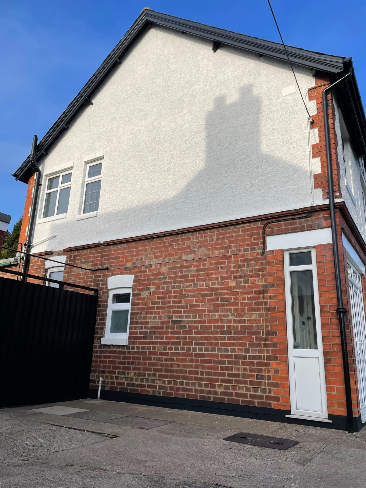 Home exterior spraying: tired house render before and after a respray. After.
