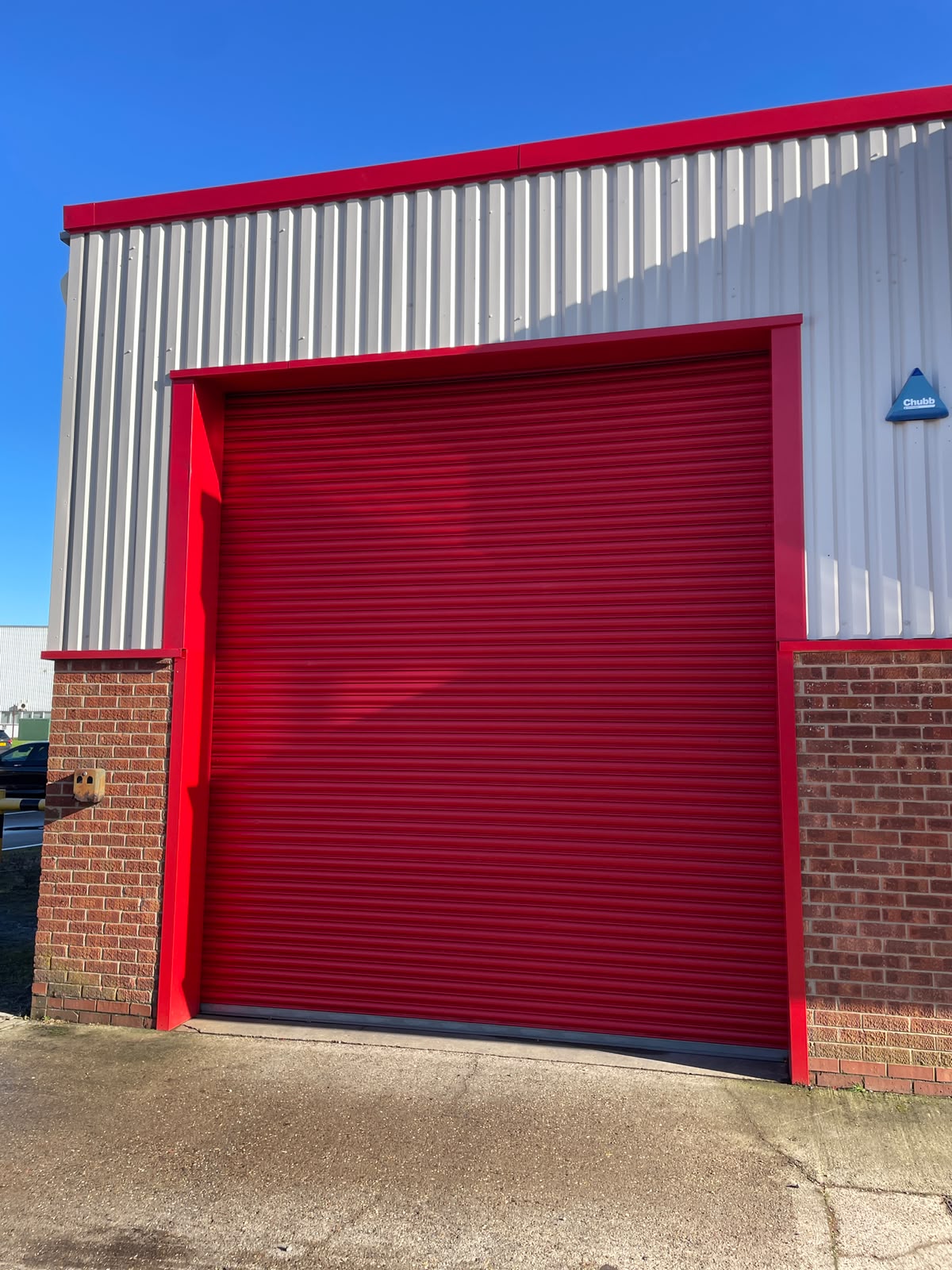 Roller shutter spraying: weathered commercial roller shutters before and after a respray. After.